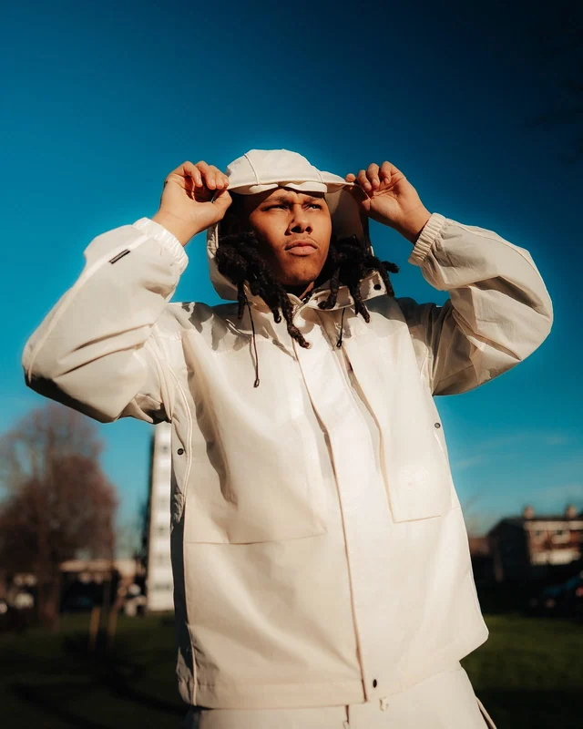 LZEE in a white hooded jacket