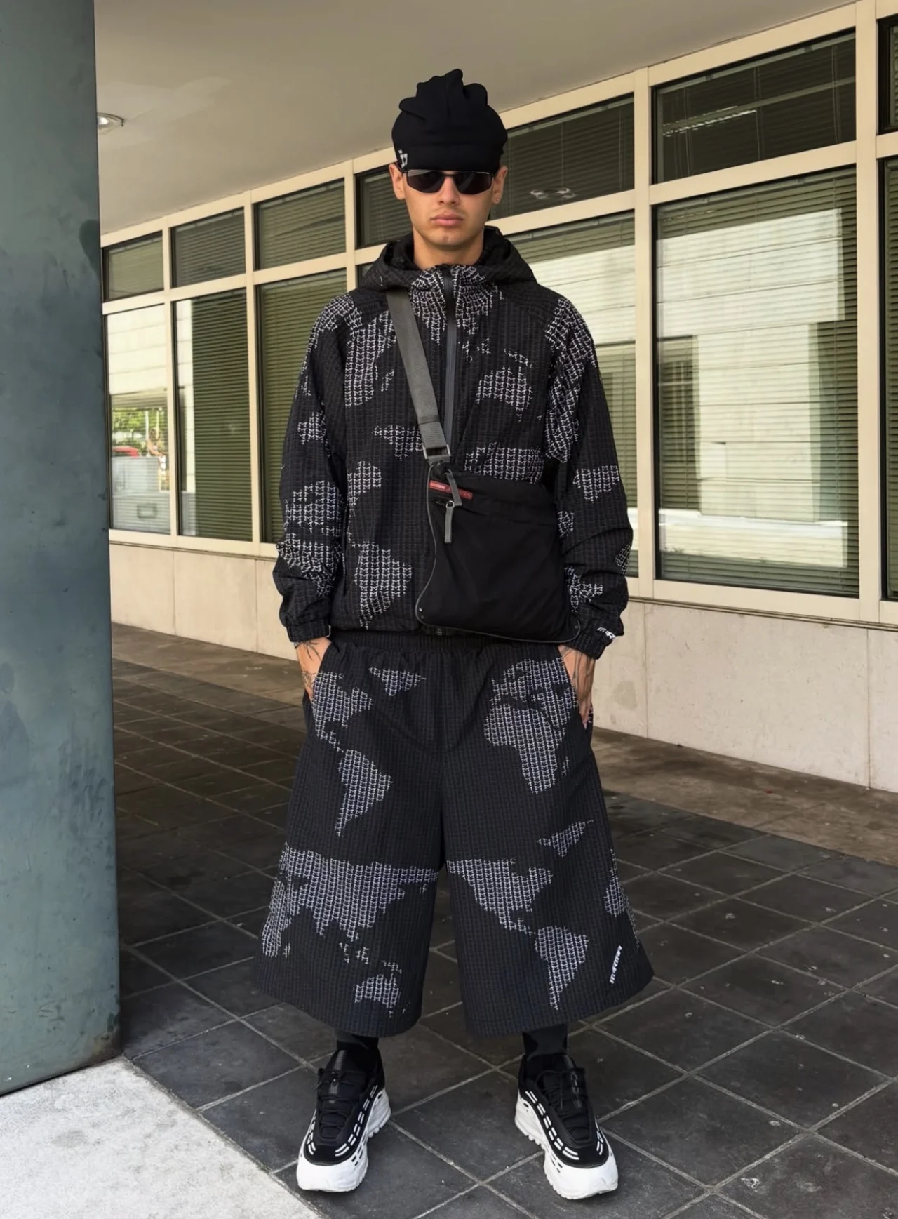 DACI wearing a matching black patterned jacket and shorts