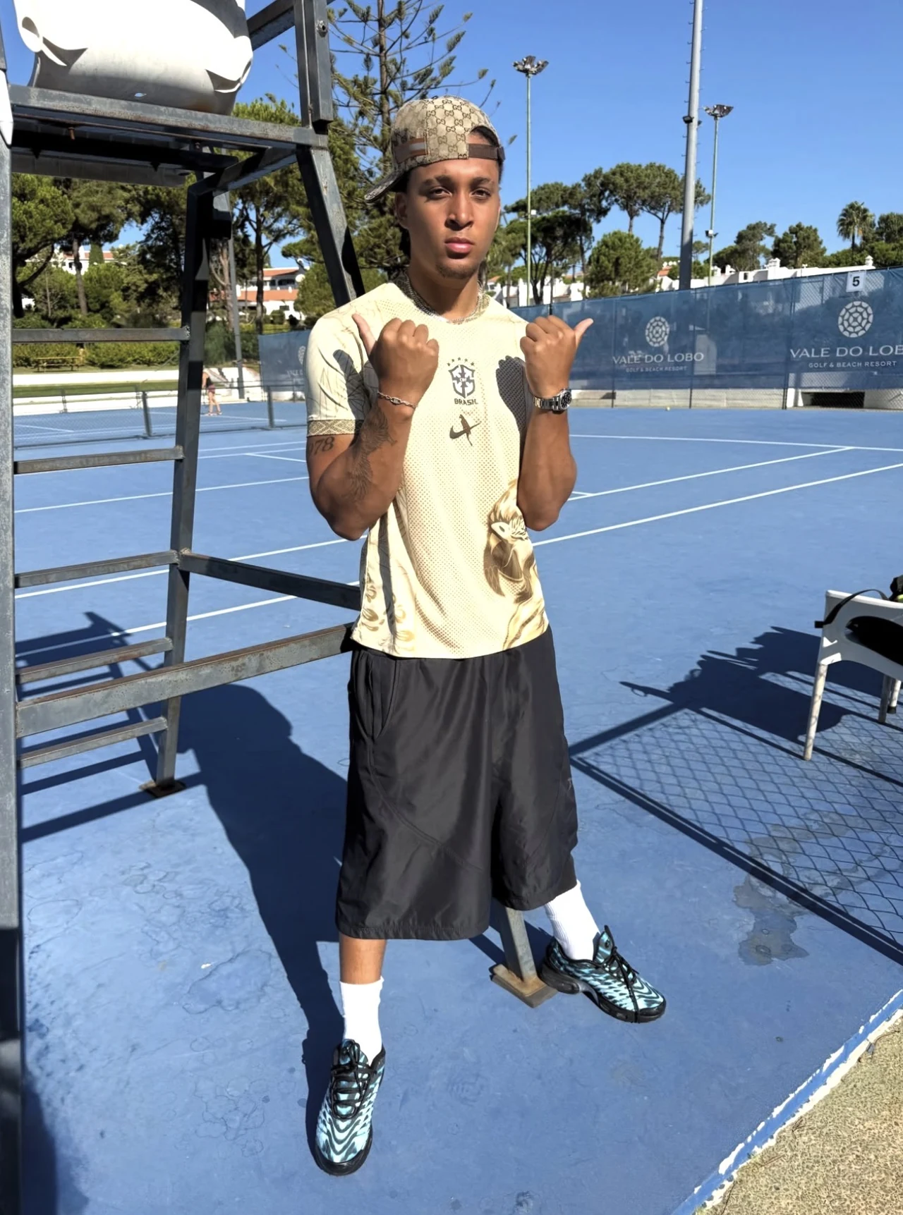 FIN wearing a Brazil football shirt on a tennis court