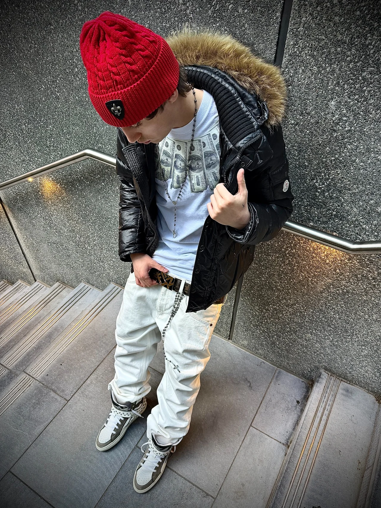 TED wearing a red beanie and black jacket in a stairwell