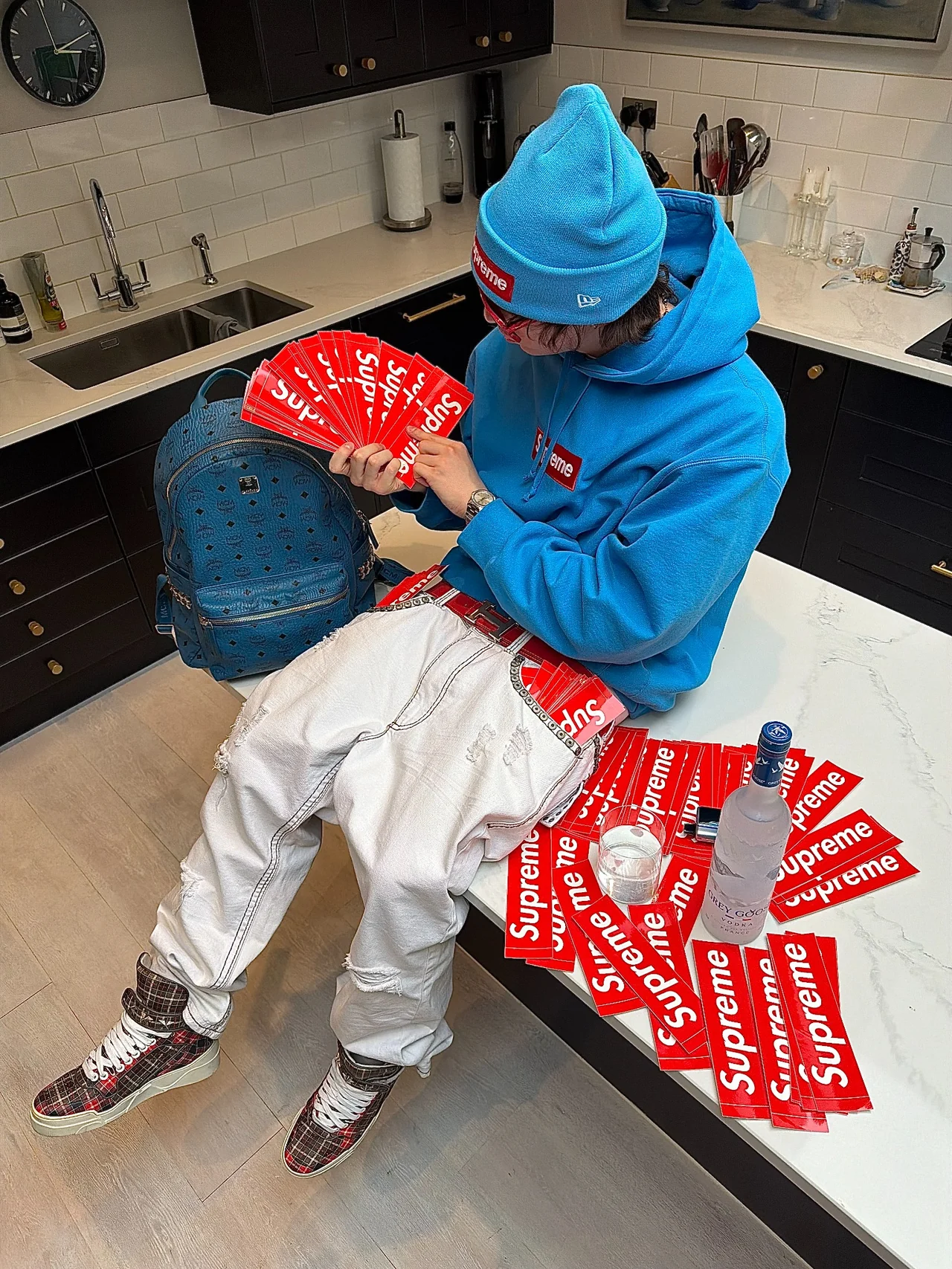 TED wearing a blue Supreme hoodie and beanie